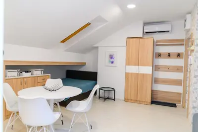 a kitchen and dining room with a table and chairs at Sky Lux in Soko Banja