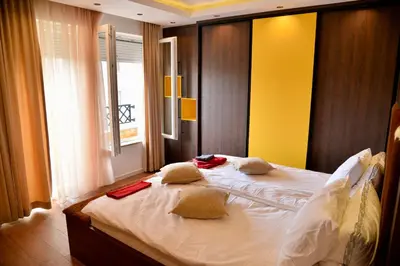 a bedroom with a bed with two pillows on it at Bella Superior Apartment in Kruševac