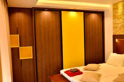 a bedroom with a bed with a red bag on it at Bella Superior Apartment in Kruševac