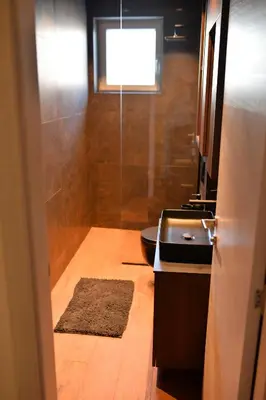 a bathroom with a shower and a toilet and a sink at Bella Superior Apartment in Kruševac