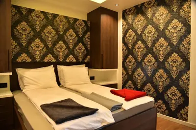 a bedroom with two beds with towels on them at Bella Superior Studio in Kruševac