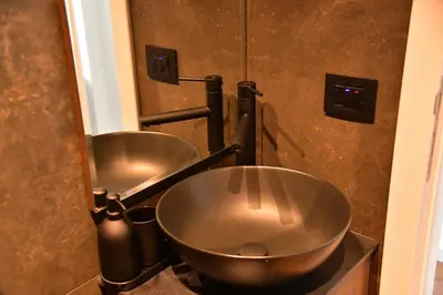 a bathroom with two metal bowls on a counter at Bella Superior Studio in Kruševac