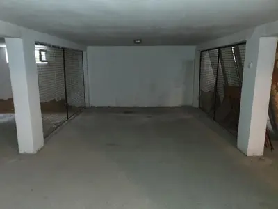 an empty room with a white wall and windows at Apartman Lan - Free parking in Vranje