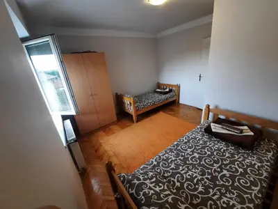 a small bedroom with a bed and a window at Apartman Lan - Free parking in Vranje