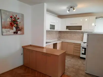 a kitchen with white cabinets and a counter top at Apartman Lan - Free parking in Vranje