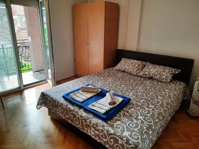 a bedroom with a bed with a tray of food on it at Apartman Lan - Free parking in Vranje