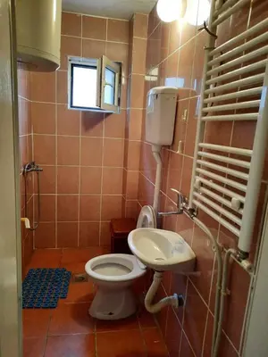 a bathroom with a toilet and a sink at Apartman Lan - Free parking in Vranje