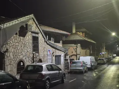 a group of cars parked on a street at night at Yugoslavija 2 centar in Aleksandrovac