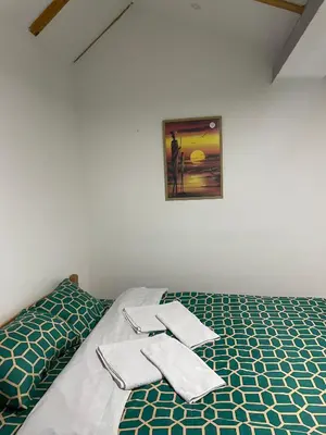 a bedroom with a bed with towels on it at Yugoslavija 2 centar in Aleksandrovac
