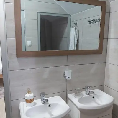 a bathroom with two sinks and a mirror at Yugoslavija 2 centar in Aleksandrovac