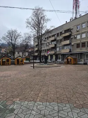 an empty courtyard with a building in the background at Yugoslavija 2 centar in Aleksandrovac