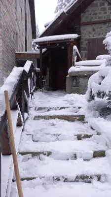 a snow covered path in front of a building at VILA 51 KOPAONIK CENTAR in Kopaonik