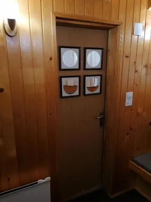 a door with two plates on it in a room at VILA 51 KOPAONIK CENTAR in Kopaonik