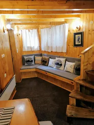 a room with a couch in a wooden cabin at VILA 51 KOPAONIK CENTAR in Kopaonik