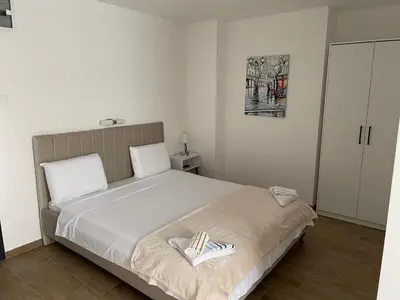 a bedroom with a bed with a pair of shoes on it at Prenociste 