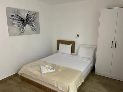 a small bedroom with a bed and a painting on the wall at Prenociste 