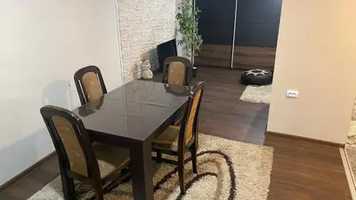 a dining room with a black table and chairs at Arni apartments in Donja Vrežina