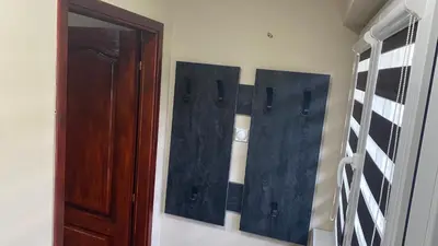 a room with a wooden door and a wall with a mirror at Arni apartments in Donja Vrežina