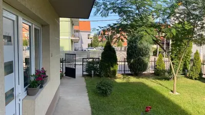 a porch of a house with a yard at Arni apartments in Donja Vrežina