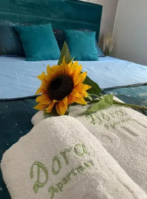 a sunflower sitting on top of a bed with a towel at Dora Lux & Free Indoor Parking in Vrnjačka Banja