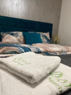 a bed with a white towel on top of it at Dora Lux & Free Indoor Parking in Vrnjačka Banja