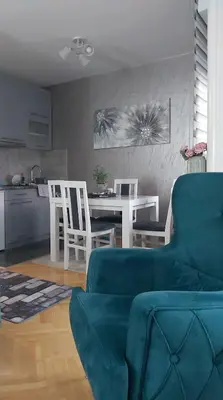 a living room with a couch and a table and chairs at Dora Lux & Free Indoor Parking in Vrnjačka Banja