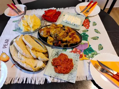a table topped with plates of food on a table at Vujanac vikend kuća in Raška