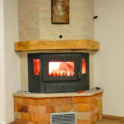 a wood burning stove in a room at Vujanac vikend kuća in Raška