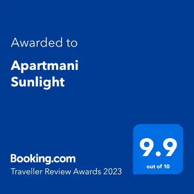 a blue text box with the words upgraded to apartment sunlight at Apartmani Sunlight in Vrnjačka Banja