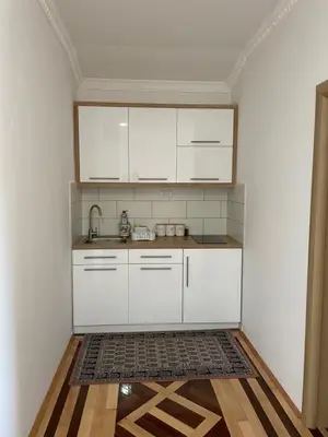 a kitchen with white cabinets and a sink at Apartman AS in Vrnjačka Banja