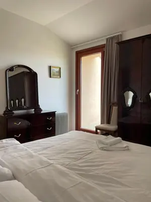 a bedroom with a bed and a dresser with a tv at Apartman AS in Vrnjačka Banja