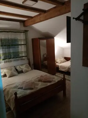 a bedroom with two beds and a mirror at Apartman Konak in Zaječar