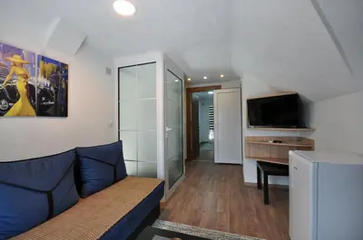a living room with a couch and a flat screen tv at Stil Park Apartmani in Vrnjačka Banja