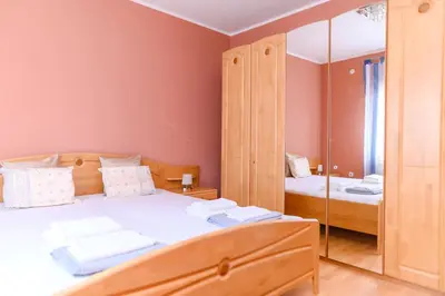 a bedroom with a bed and a mirror at Arsic-Home in Soko Banja