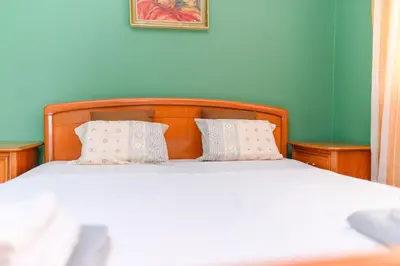 a bedroom with a bed with two pillows on it at Arsic-Home in Soko Banja