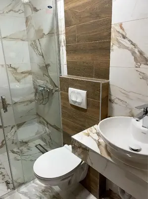 a bathroom with a toilet and a sink at Pink House Apartments in Jagodina