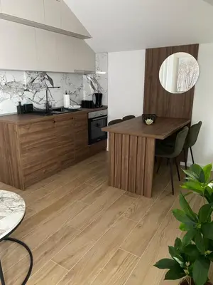 a kitchen with a wooden island in a room at Apartmani Lazarevic Jagodina in Jagodina
