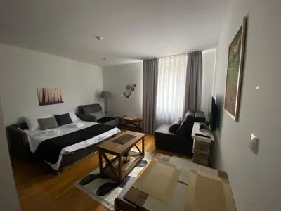 a bedroom with a bed and a living room at Mountain Story in Brzeće