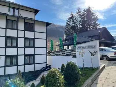 a hotel with a sign in front of a building at Mountain Story in Brzeće