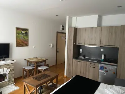 a living room with a kitchen and a table at Mountain Story in Brzeće