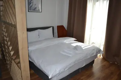 a bed with two towels on it in a bedroom at President Kop A 14 in Cajetina