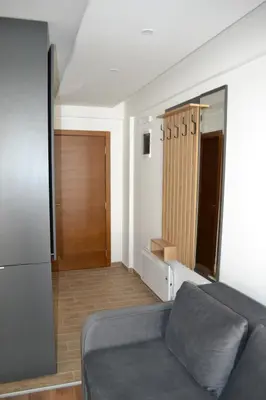 a living room with a couch and a sliding glass door at President Kop A 14 in Cajetina