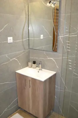 a bathroom with a sink and a mirror at President Kop A 14 in Cajetina