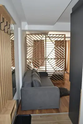 a living room with a gray couch in a room at President Kop A 14 in Cajetina