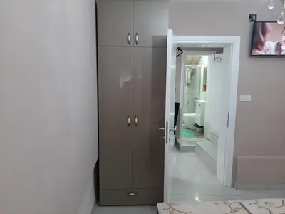 a bathroom with a brown cabinet and a mirror at Apartment Sweet dreams 4 in Niš
