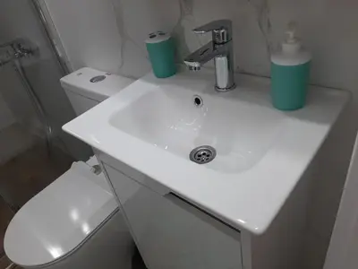 a white bathroom with a sink and a toilet at Apartment Sweet dreams 4 in Niš