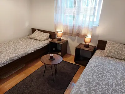 a living room with two beds and a coffee table at Promenada View Snežnik in Vrnjačka Banja
