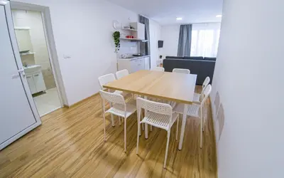 a kitchen and dining room with a wooden table and chairs at Milutinn-Visterija in Soko Banja