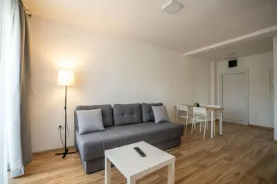 a living room with a couch and a table at Milutinn-Visterija in Soko Banja