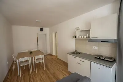 a small kitchen with a table and chairs in a room at Milutinn-Visterija in Soko Banja